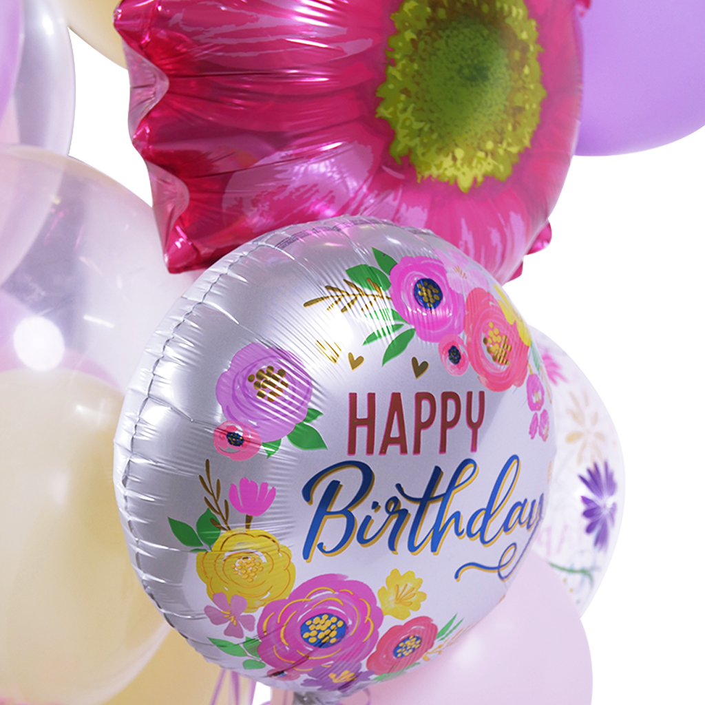 A bunch of balloons with one that says happy birthday