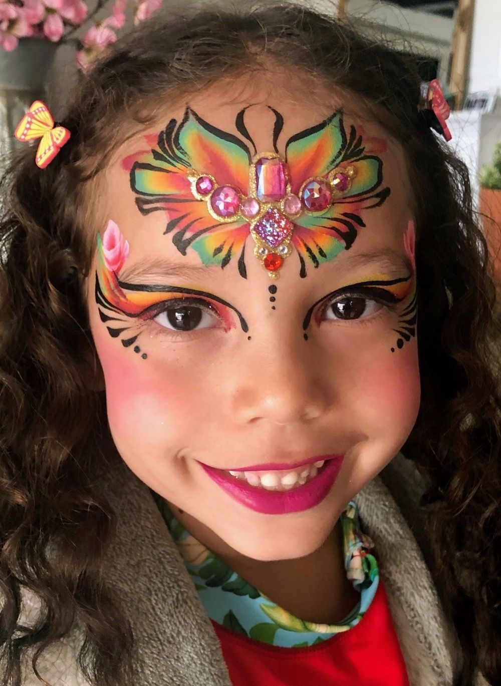 A little girl with incredible face painting by The Balloon Guy.