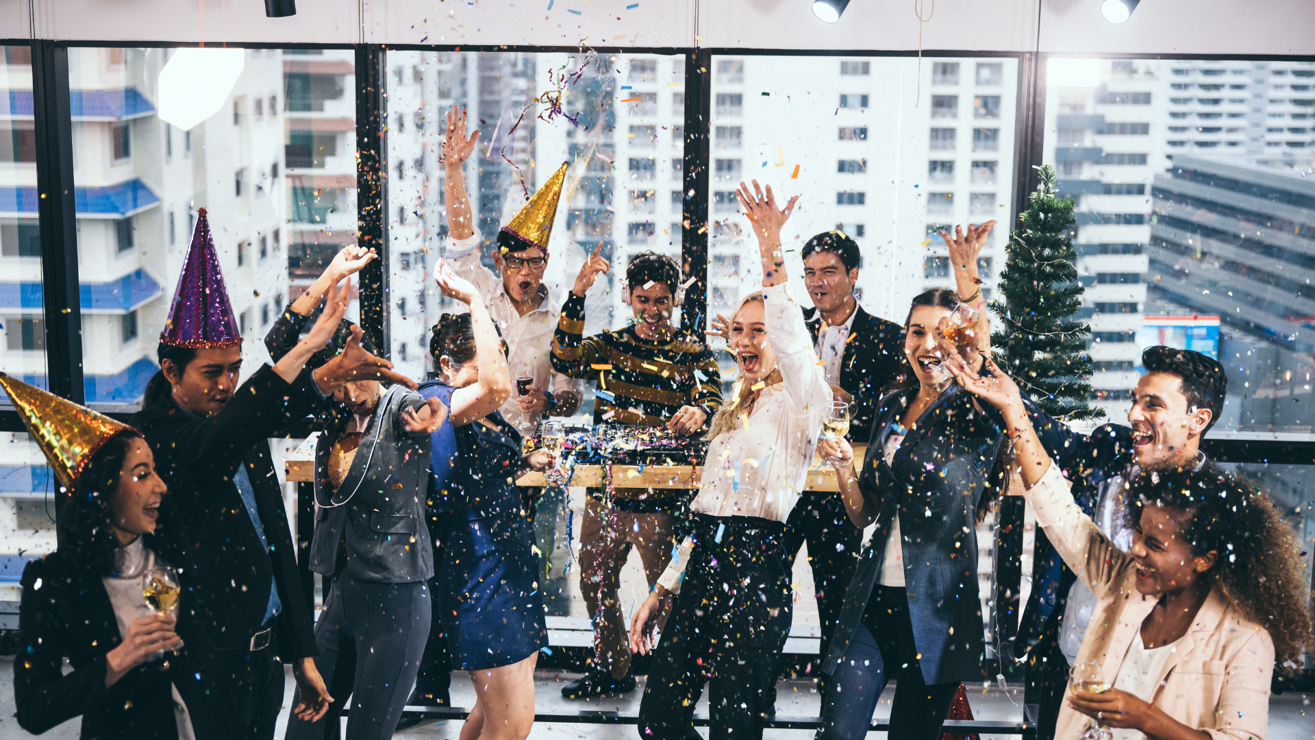 A group of people are celebrating a new year 's eve party in an office.