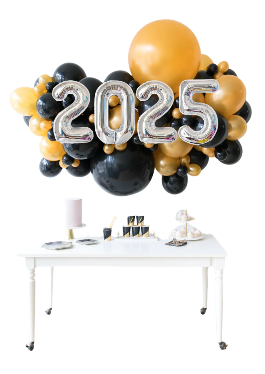 A table with a bunch of balloons that say 2025 on it.