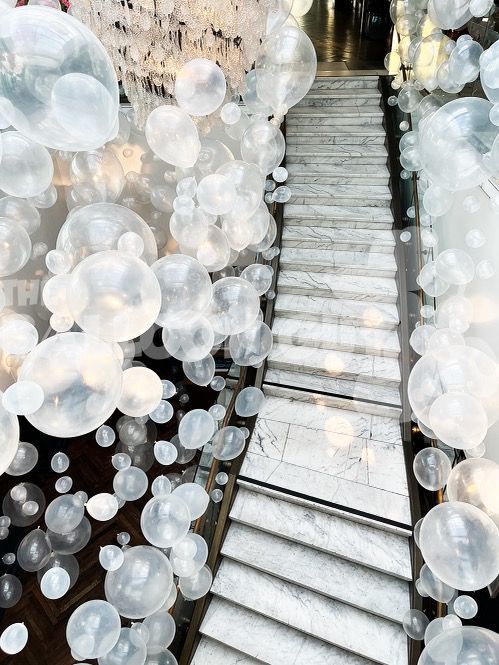 A staircase with a lot of bubbles hanging from the ceiling