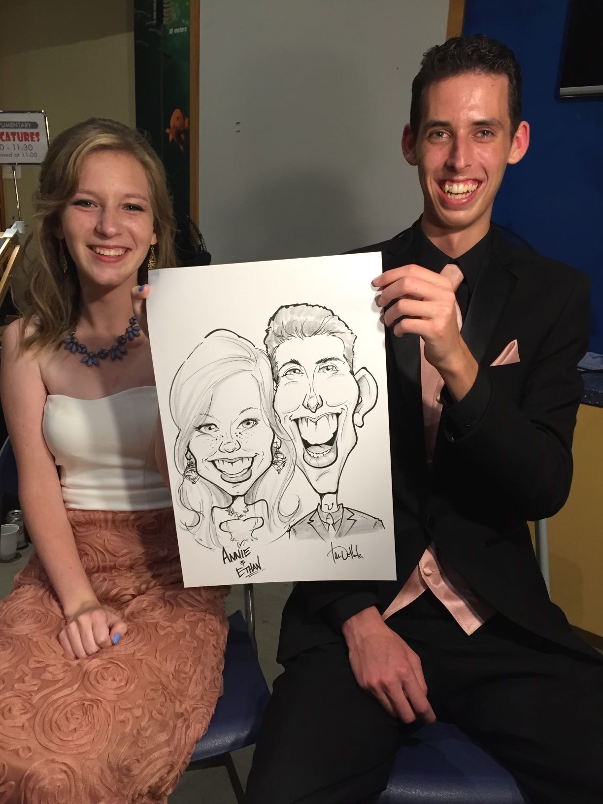 A man is holding a caricature of a woman and a man