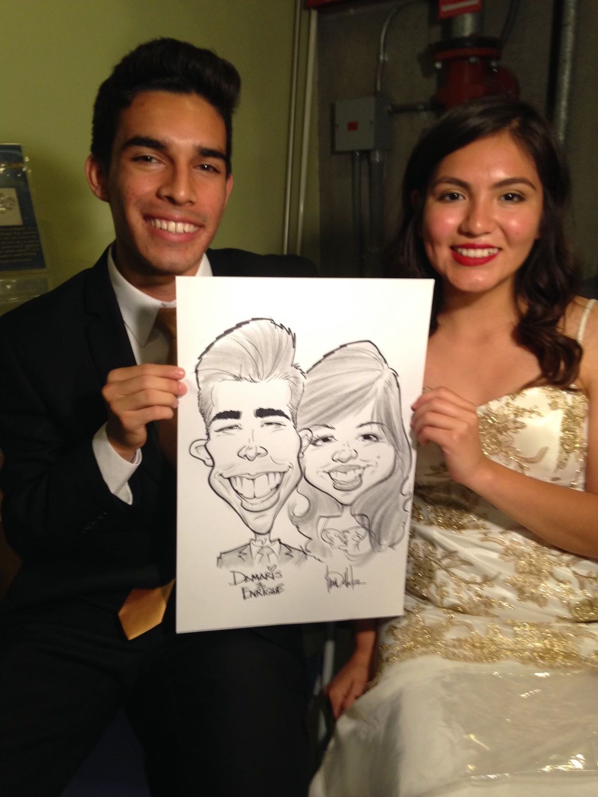 A man and a woman are holding a caricature of themselves