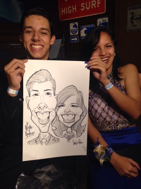 A man holds up a caricature of a man and a woman in front of a sign that says high surf