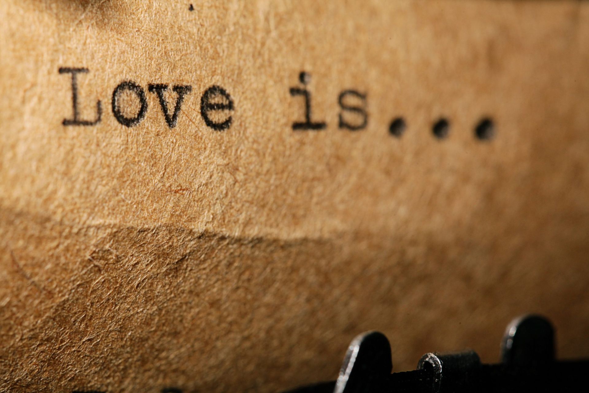 The word love is written on a piece of brown paper