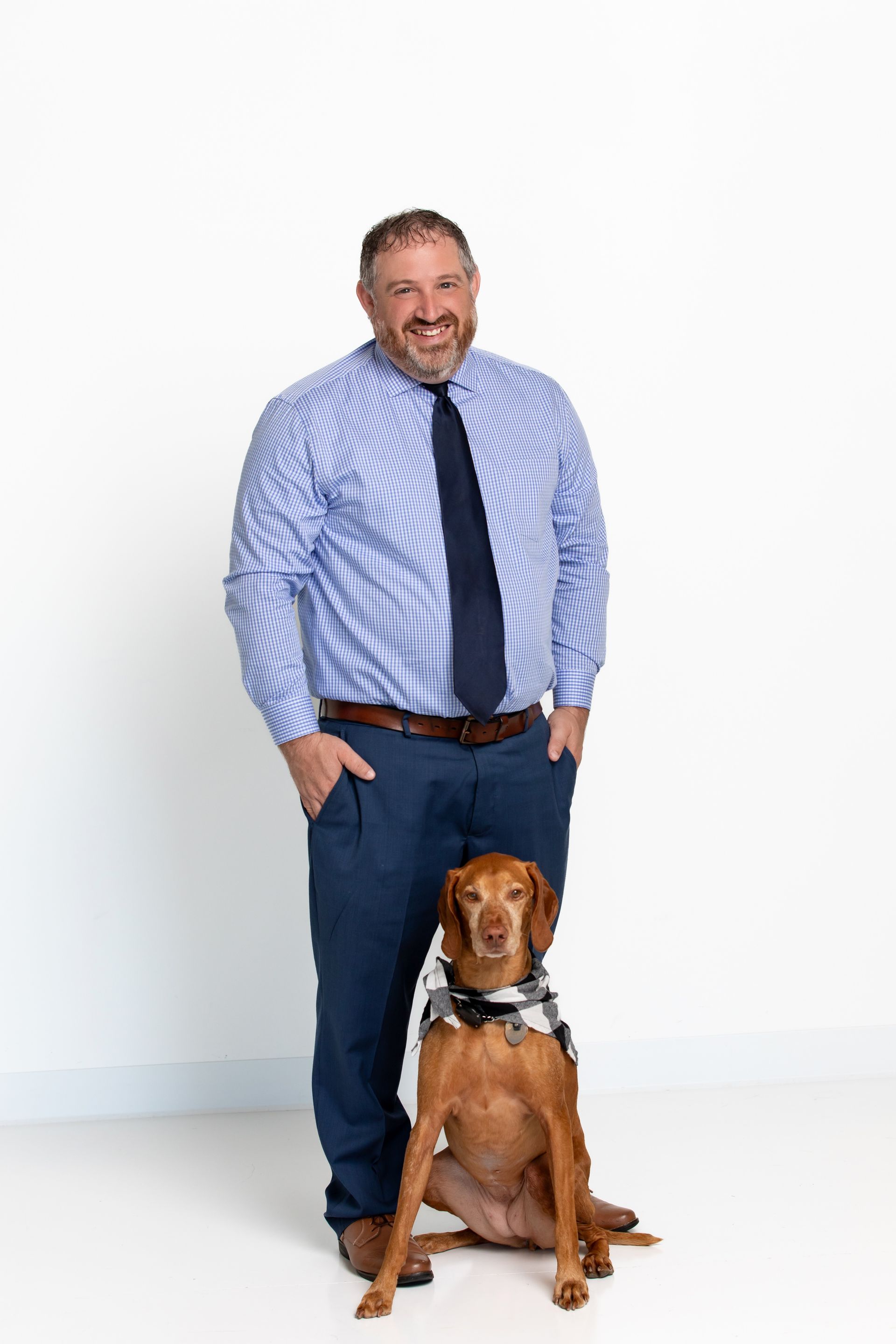 A woman is sitting at a desk talking to a man and woman.