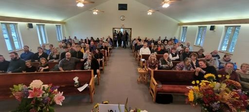 A large group of people are sitting in a church.