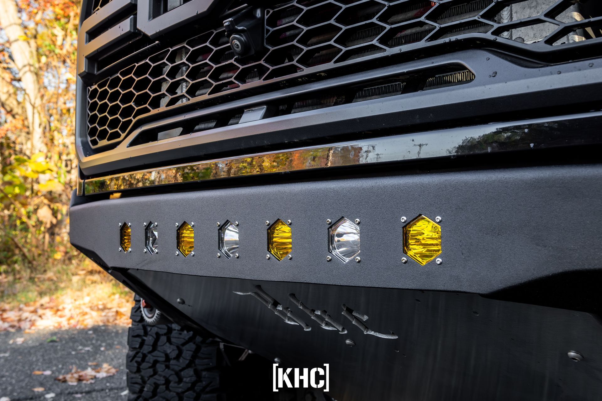 Black truck bumper with yellow and white lights.