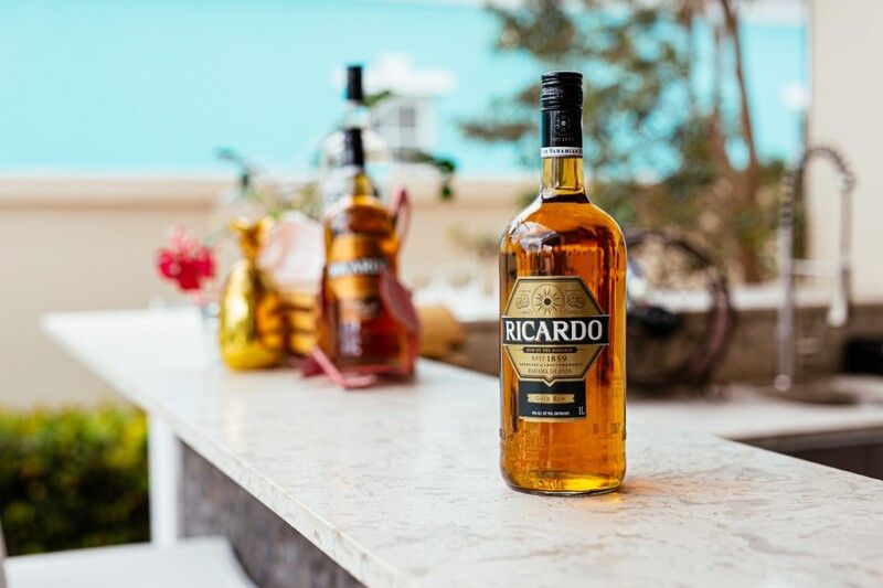 A bottle of liquor is sitting on a counter.