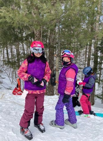 Three kids in ski gear