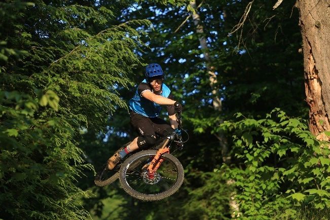 Mountain biker mid-air in the woods