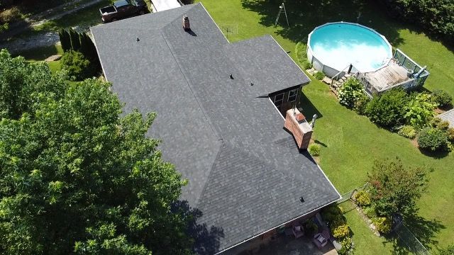an aerial view of a house with a pool in the backyard Birds Eye Roofing Group.