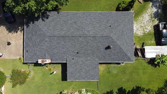 an aerial view of a house with a new roof Birds Eye Roofing Group.
