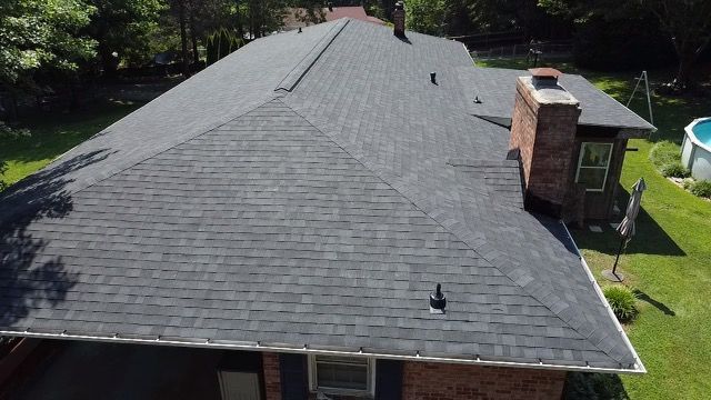 an aerial view of a house with a roof and a chimney Birds Eye Roofing Group.