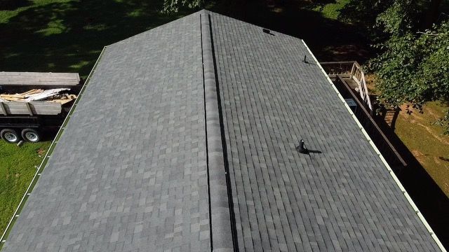 an aerial view of a house with a roof that has shingles on it Birds Eye Roofing Group.