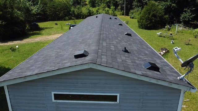 an aerial view of a house with a new roof Birds Eye Roofing Group.