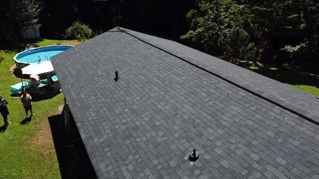 an aerial view of a house with a pool in the backyard Birds Eye Roofing Group.
