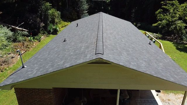 an aerial view of a roof of a house with a carport Birds Eye Roofing Group.