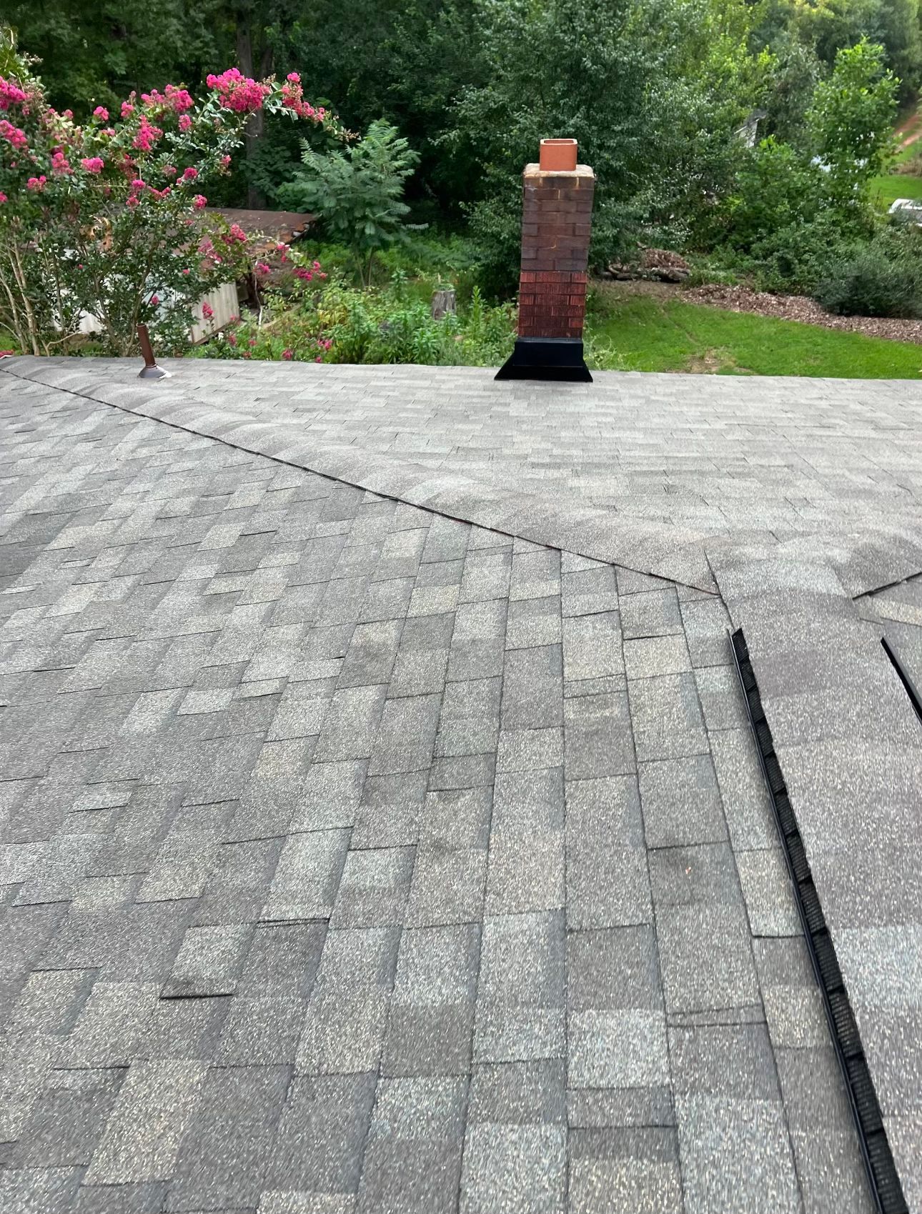 there is a chimney on the roof of a house Birds Eye Roofing Group.