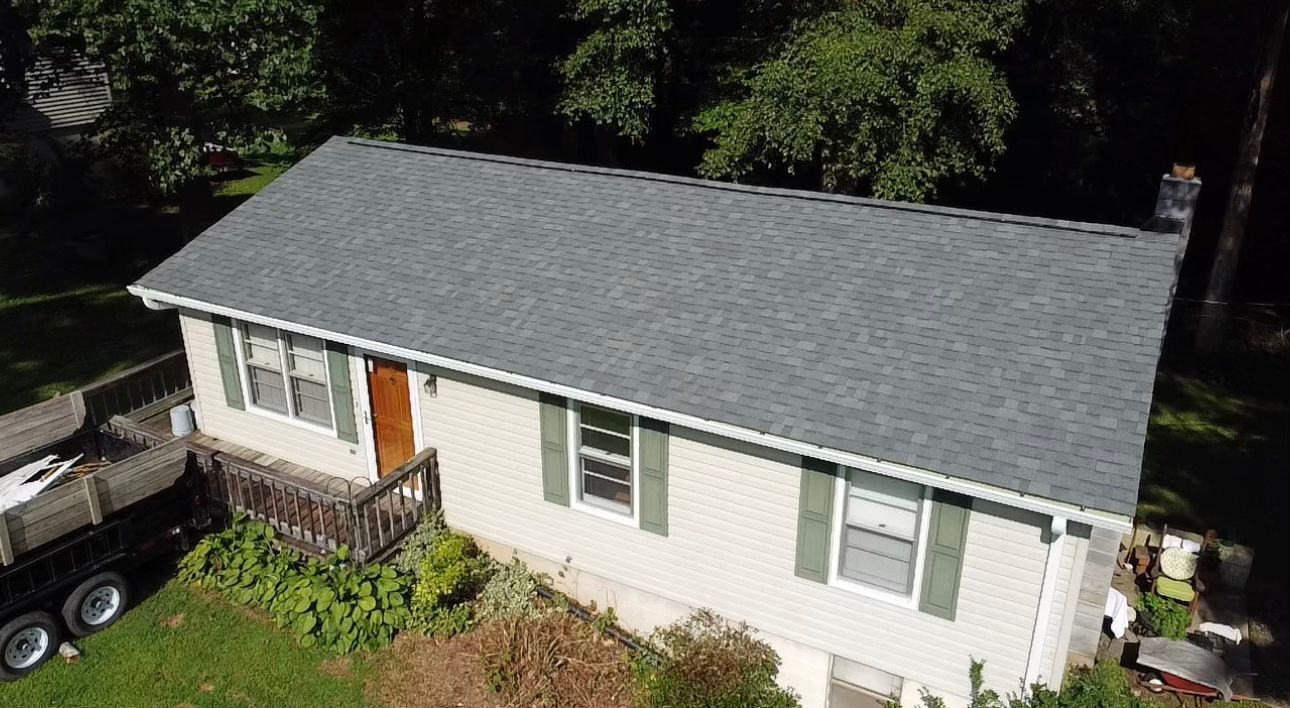 an aerial view of a house with a new roof Birds Eye Roofing Group.