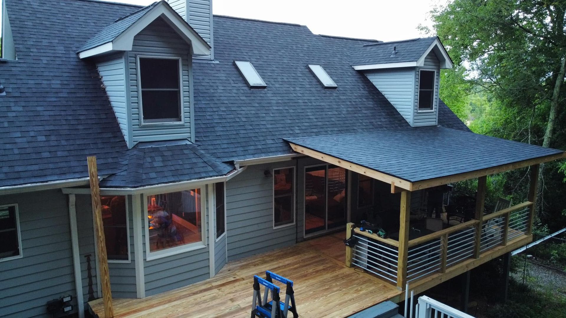 an aerial view of a house with a deck and a roof Birds Eye Roofing Group.