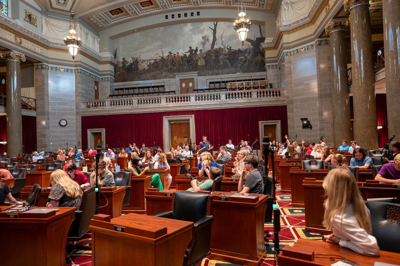 A large room with a lot of people sitting at desks