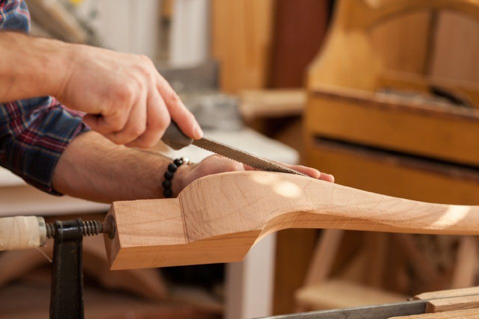 carpenter rounding the edges of a wood