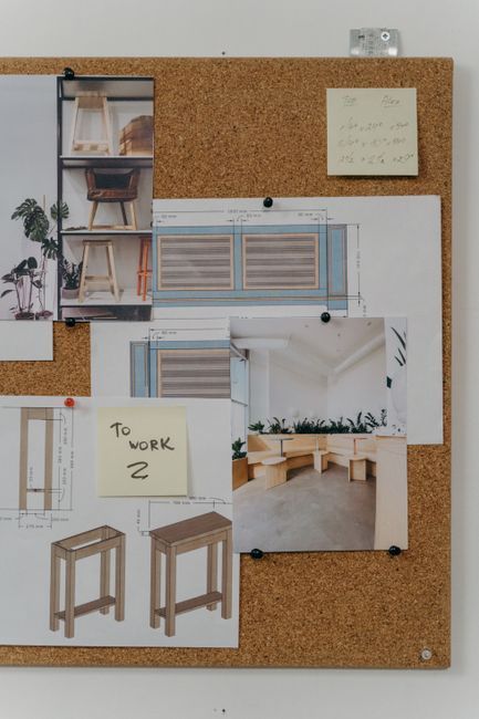 Mood board with color swatches and wireframe sketches on a desk representing therapy website design planning