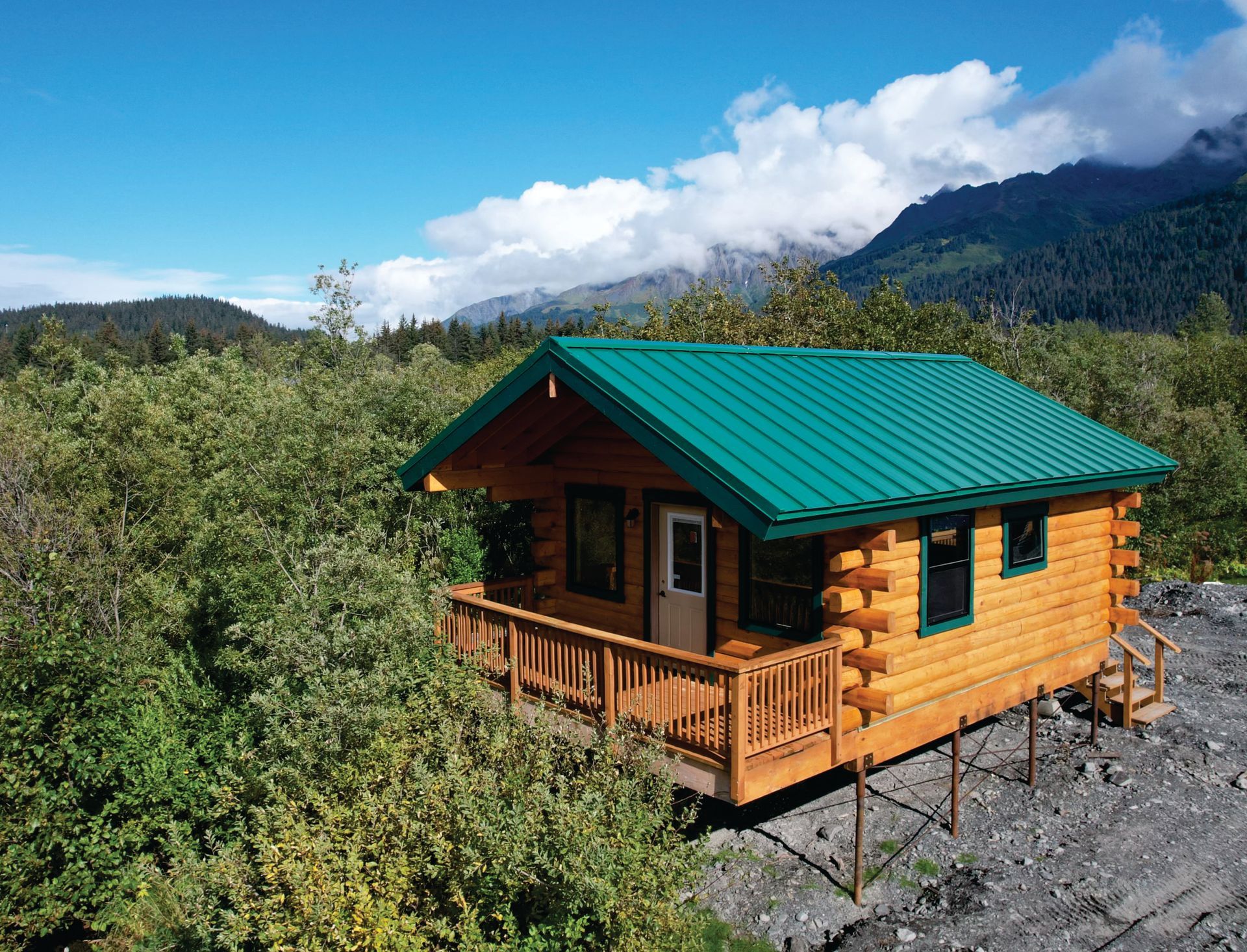 A living room in a log cabin with a couch and a rug.