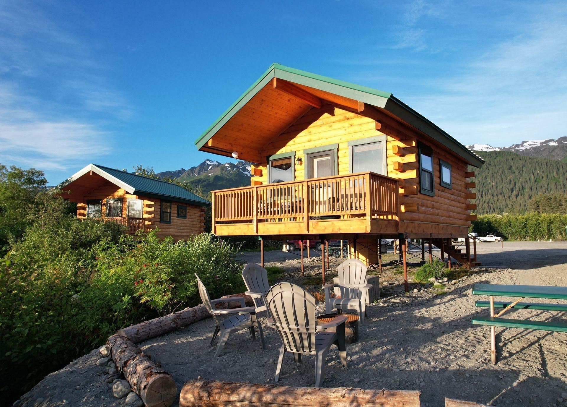 A living room in a log cabin with a couch and a rug.
