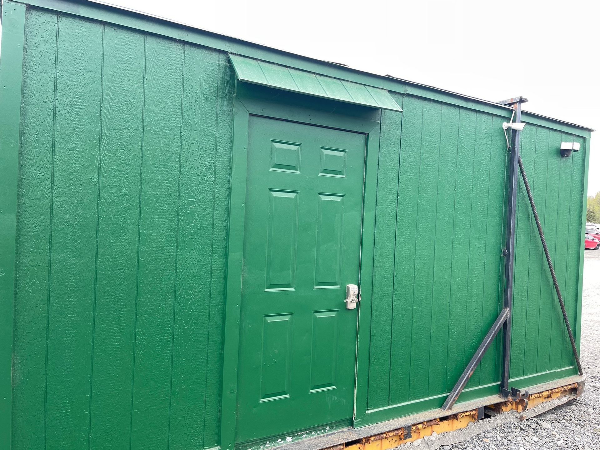 A sunset over a foggy mountain range with trees in the foreground.