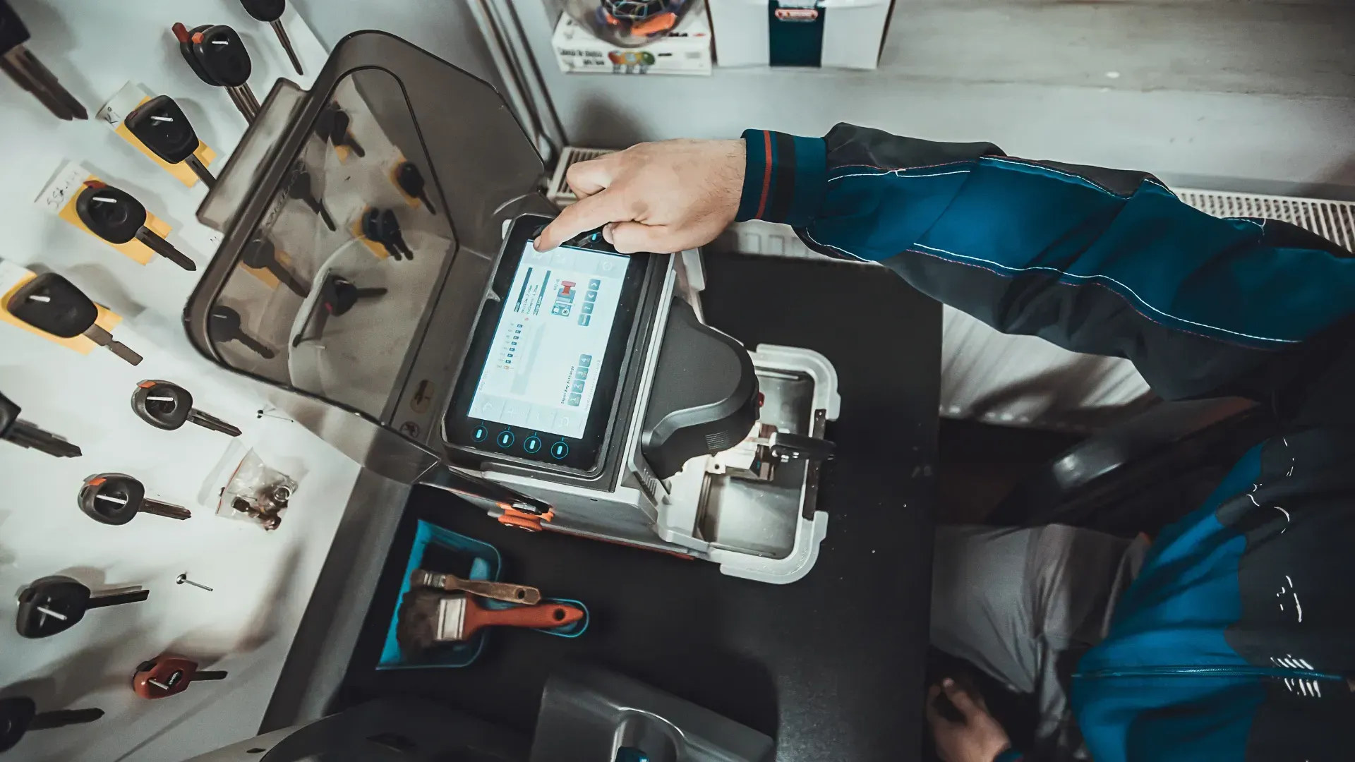 A person is using a machine to make keys.