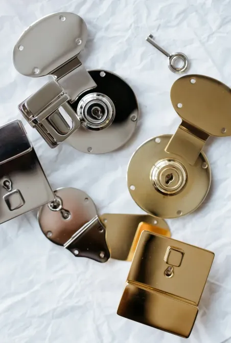 A bunch of metal parts are laying on a white cloth.
