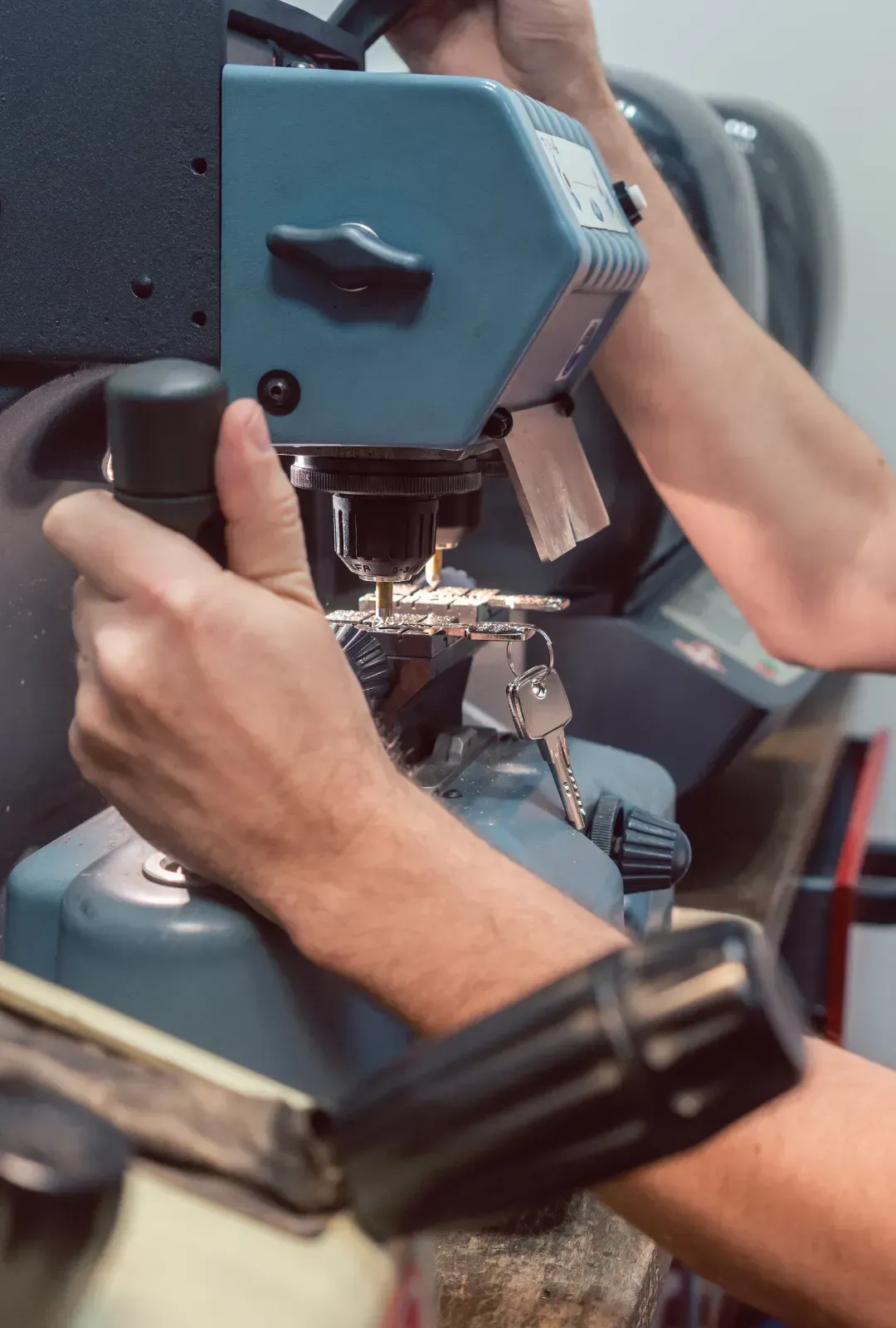 An electrician is working on an electrical outlet with a multimeter.