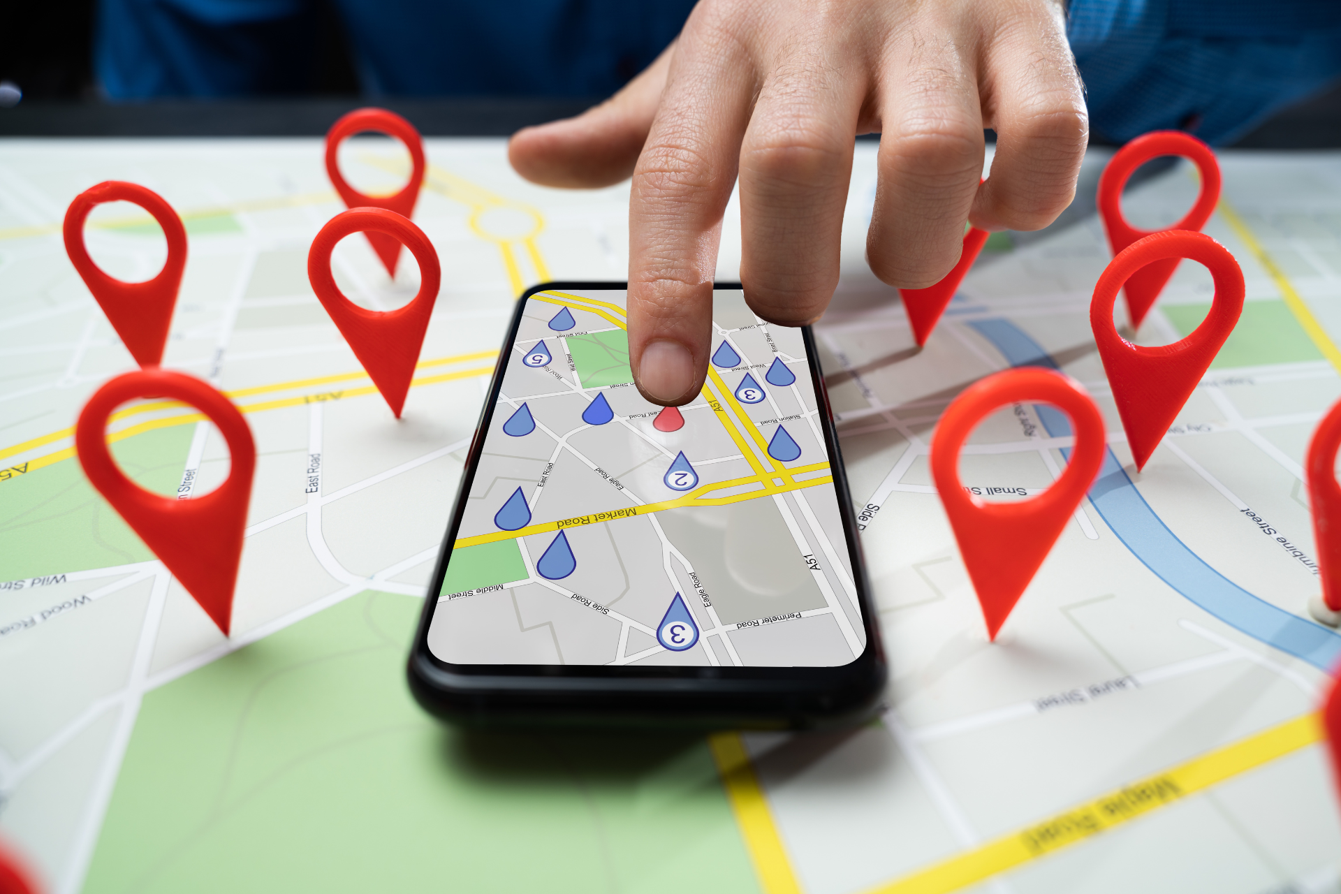 A person is using a cell phone to find a location on a map.