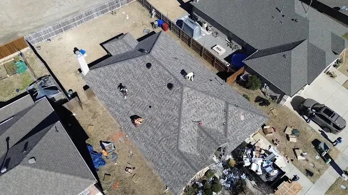 An aerial view of a roof being installed on a house.