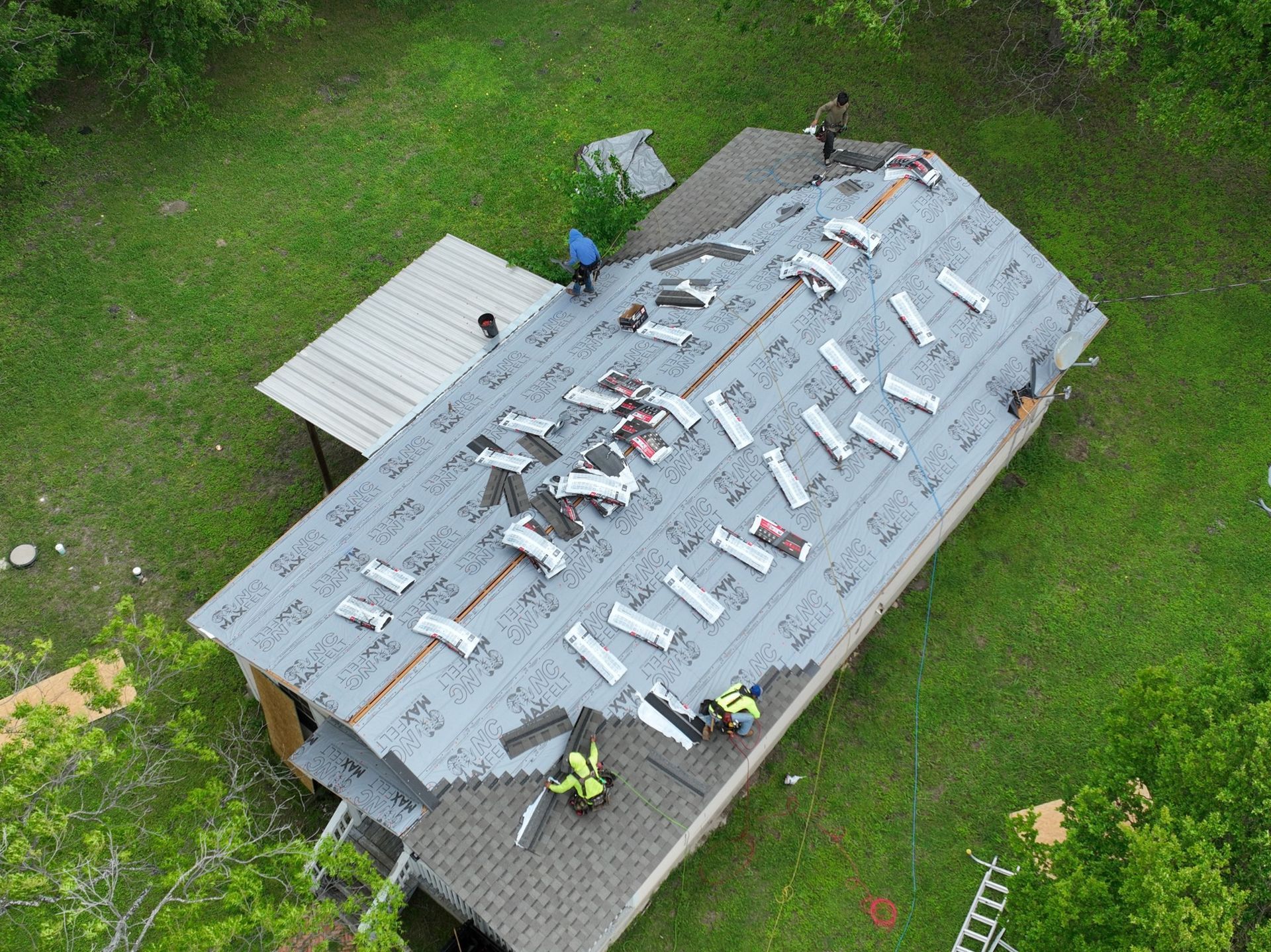 An aerial view of a roof being installed on a house.