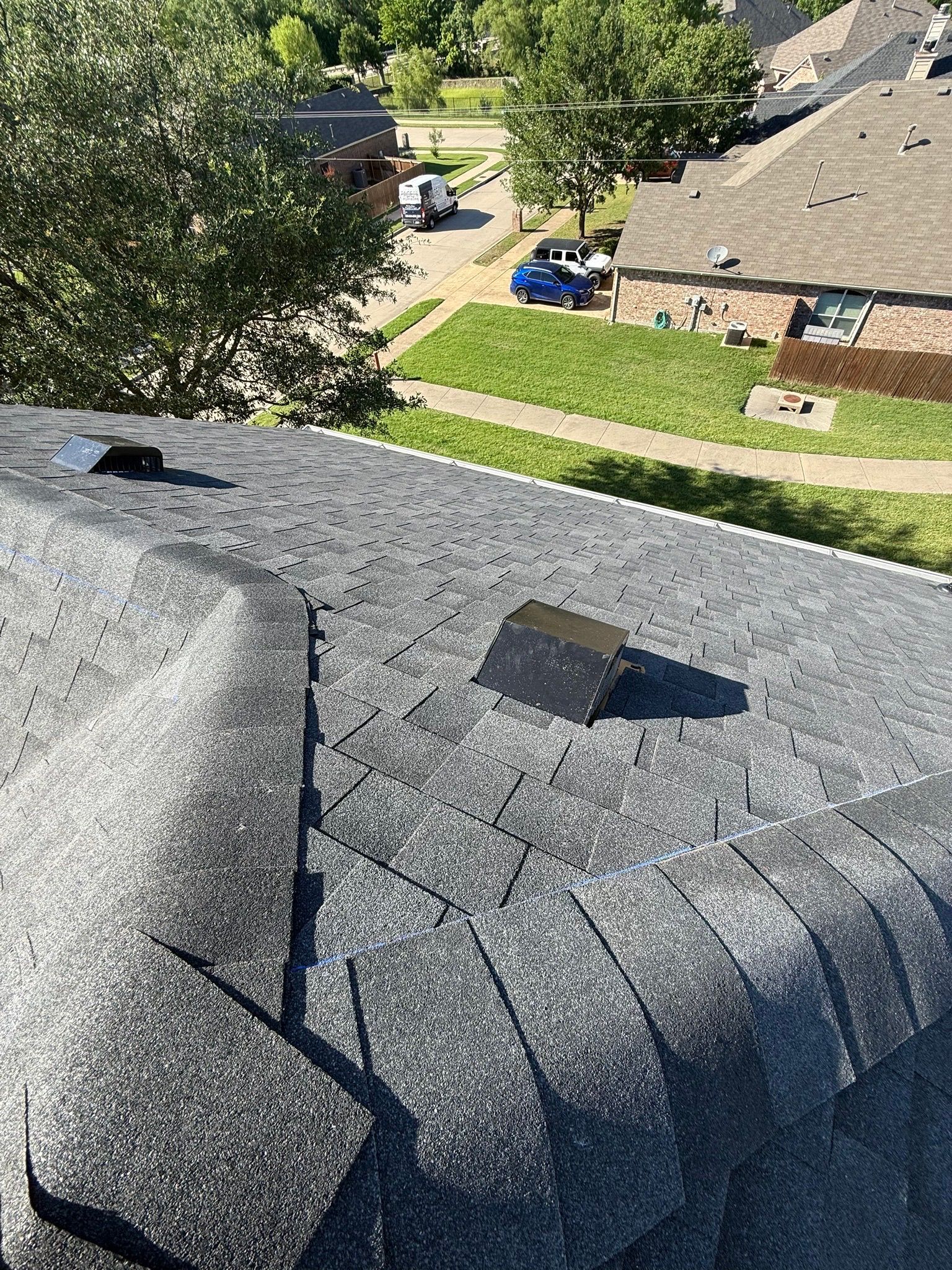An aerial view of a roof with shingles on it.