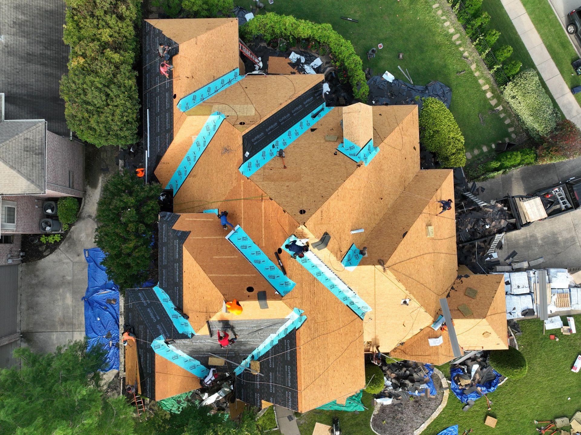 An aerial view of a house with a roof being installed