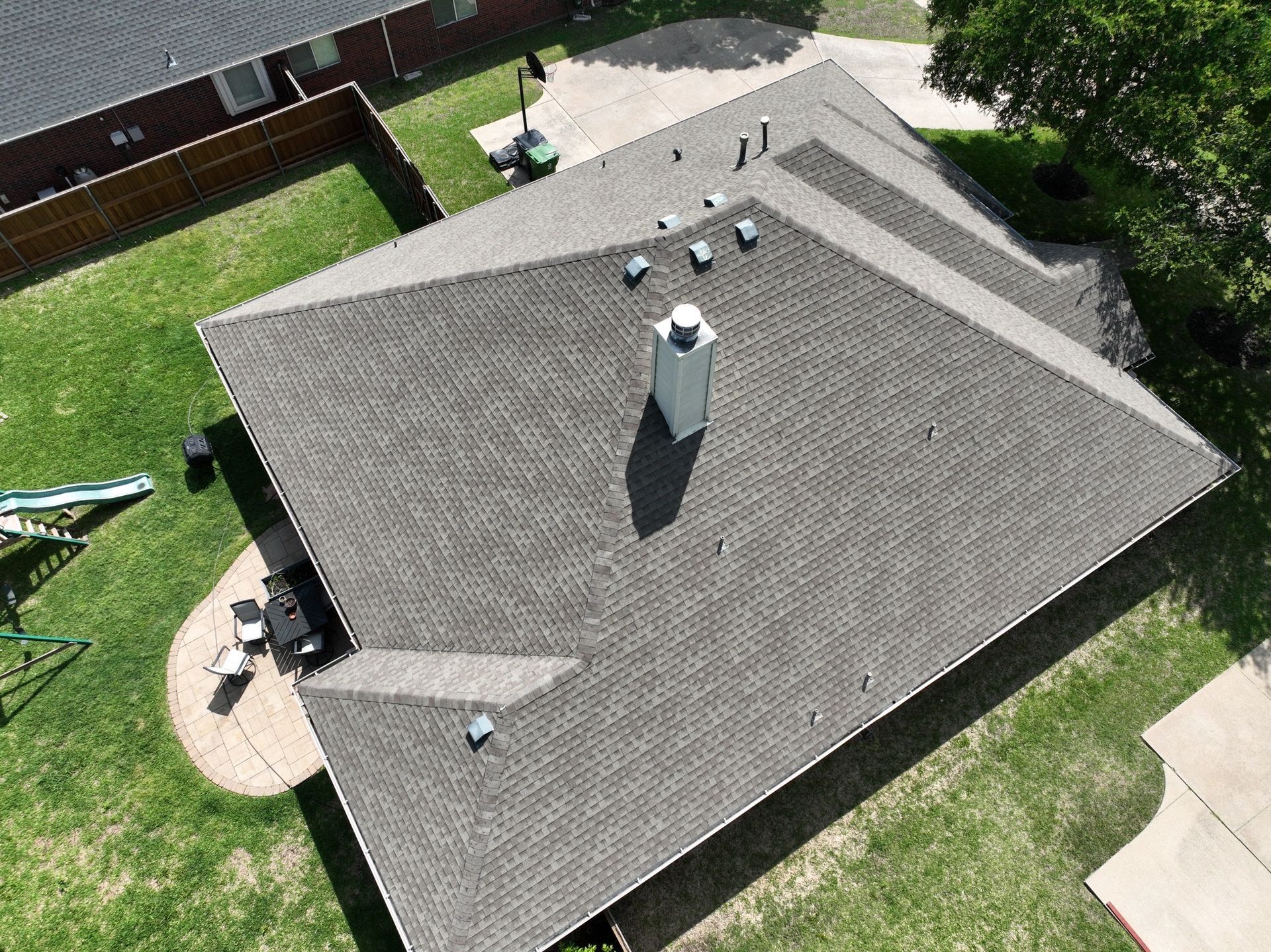 An aerial view of a roof of a house with a chimney on it.