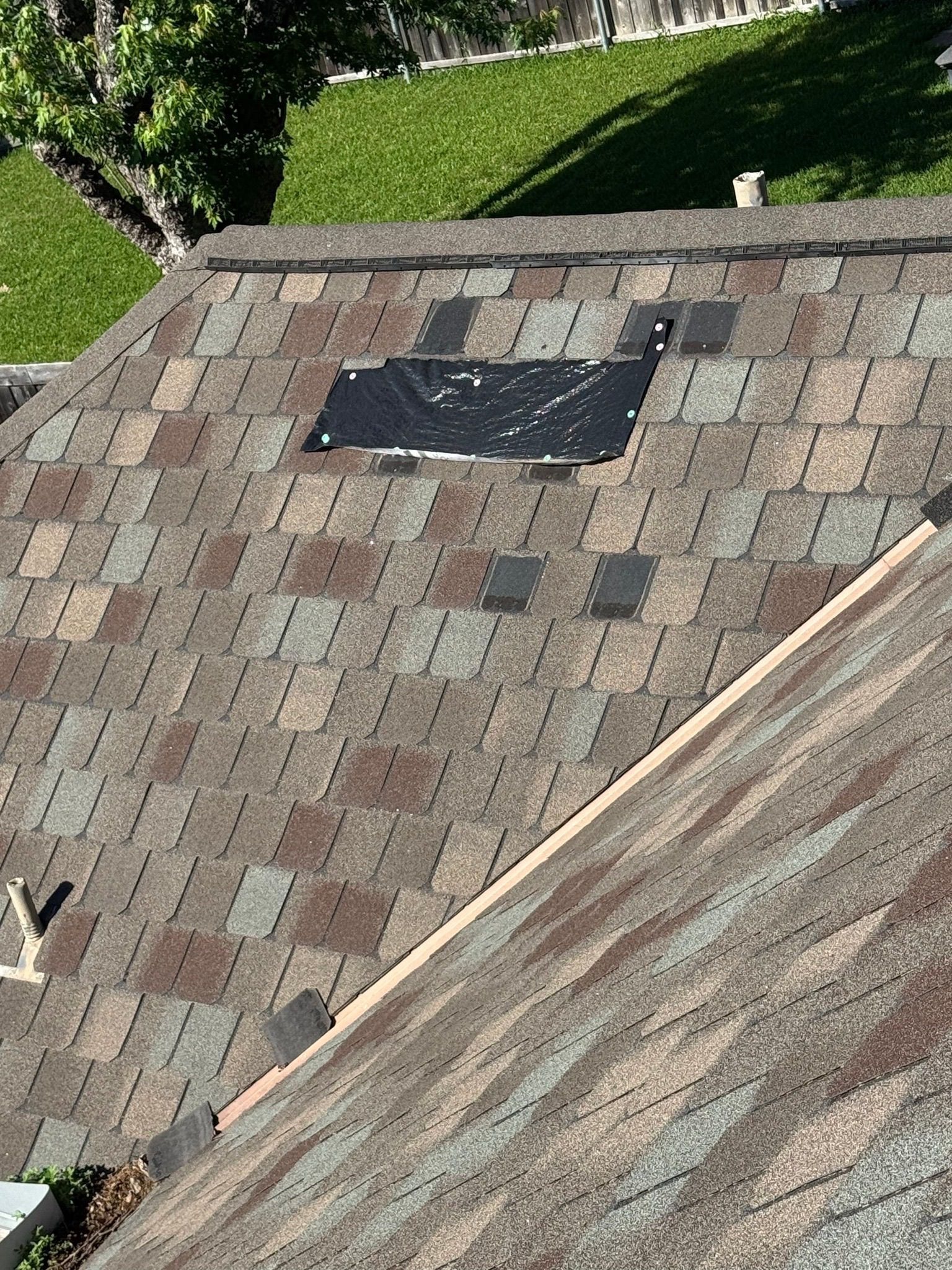 An aerial view of a roof with a hole in it.