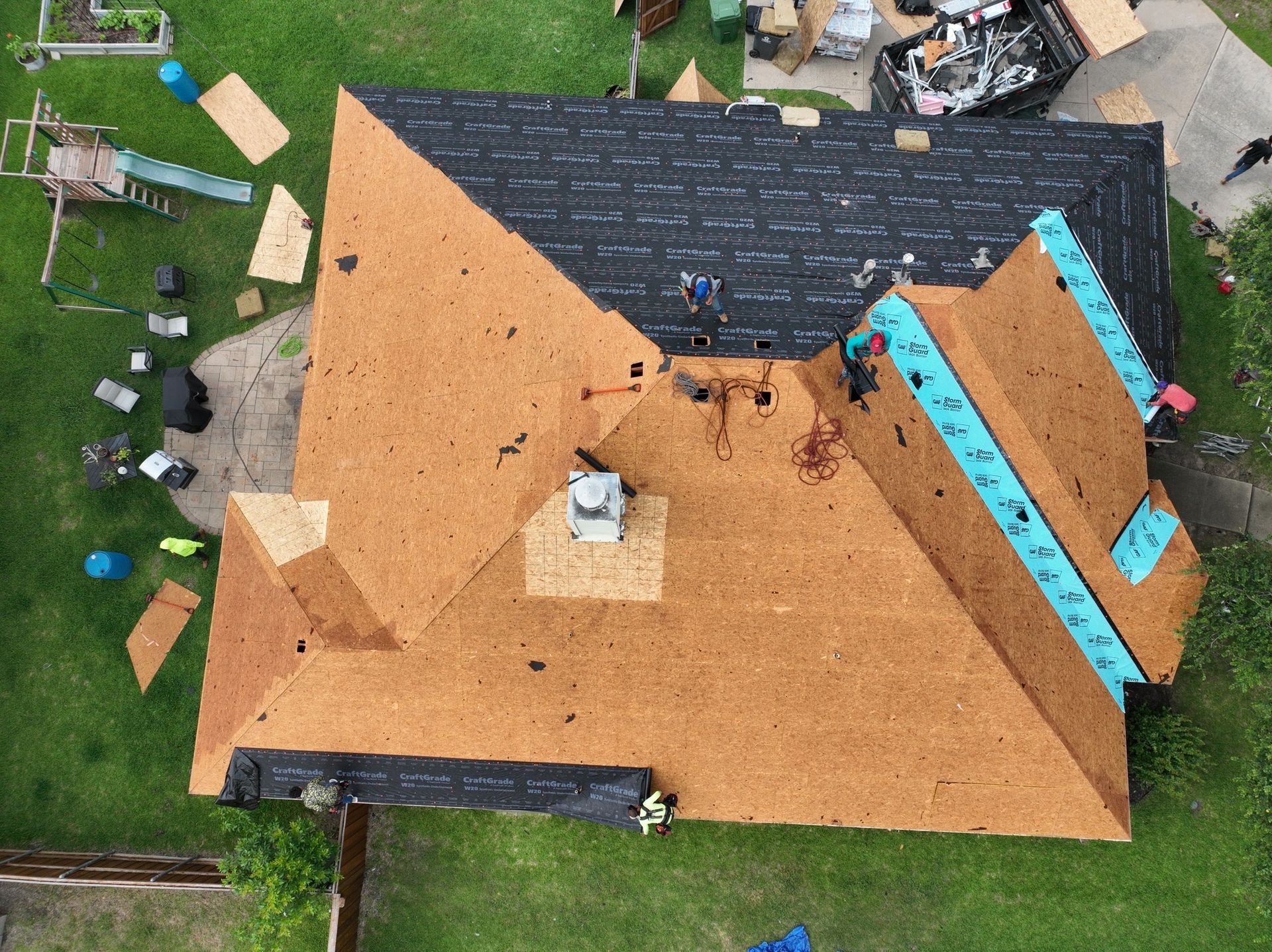 An aerial view of a roof being installed on a house.