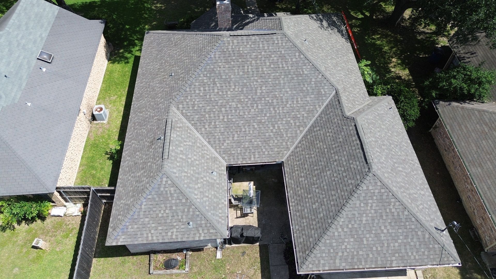 An aerial view of a house with a new roof.