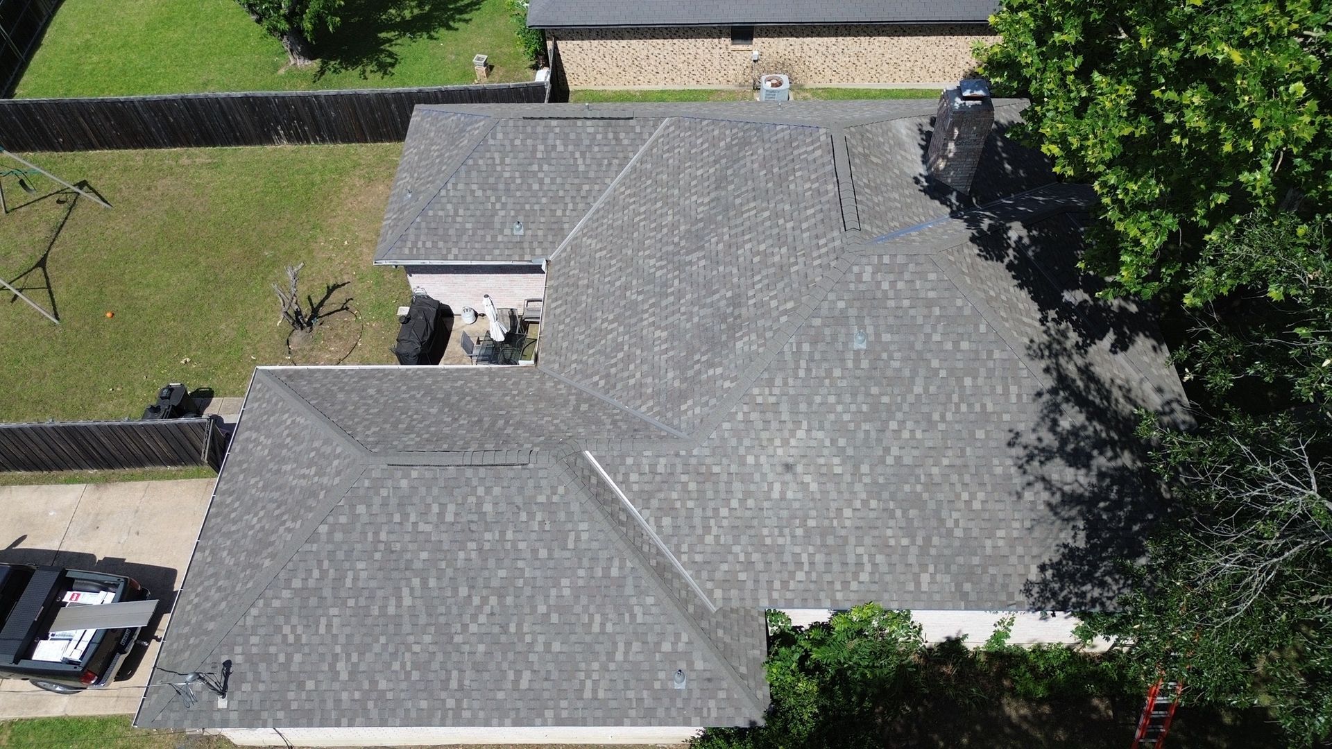 An aerial view of a house with a new roof.