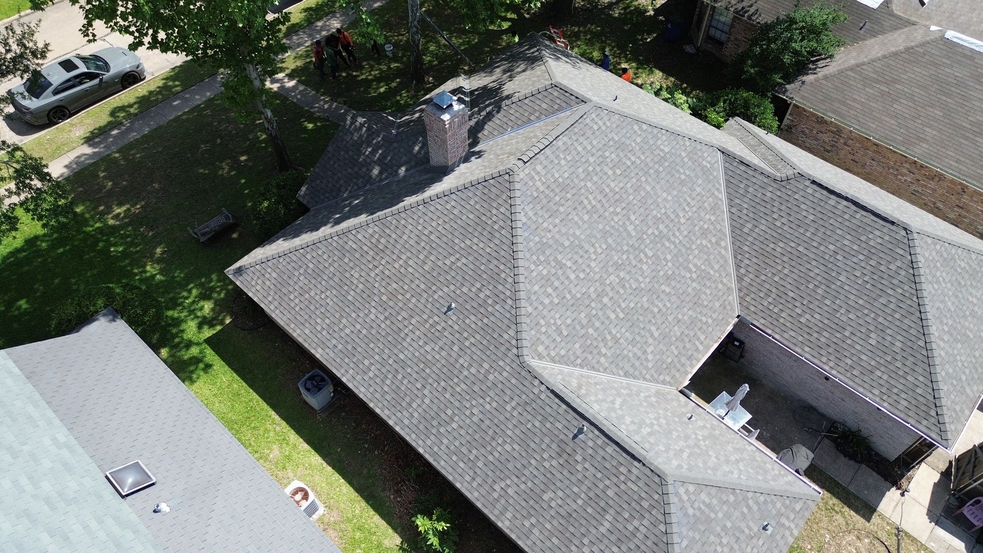 An aerial view of a house with a roof and a chimney.