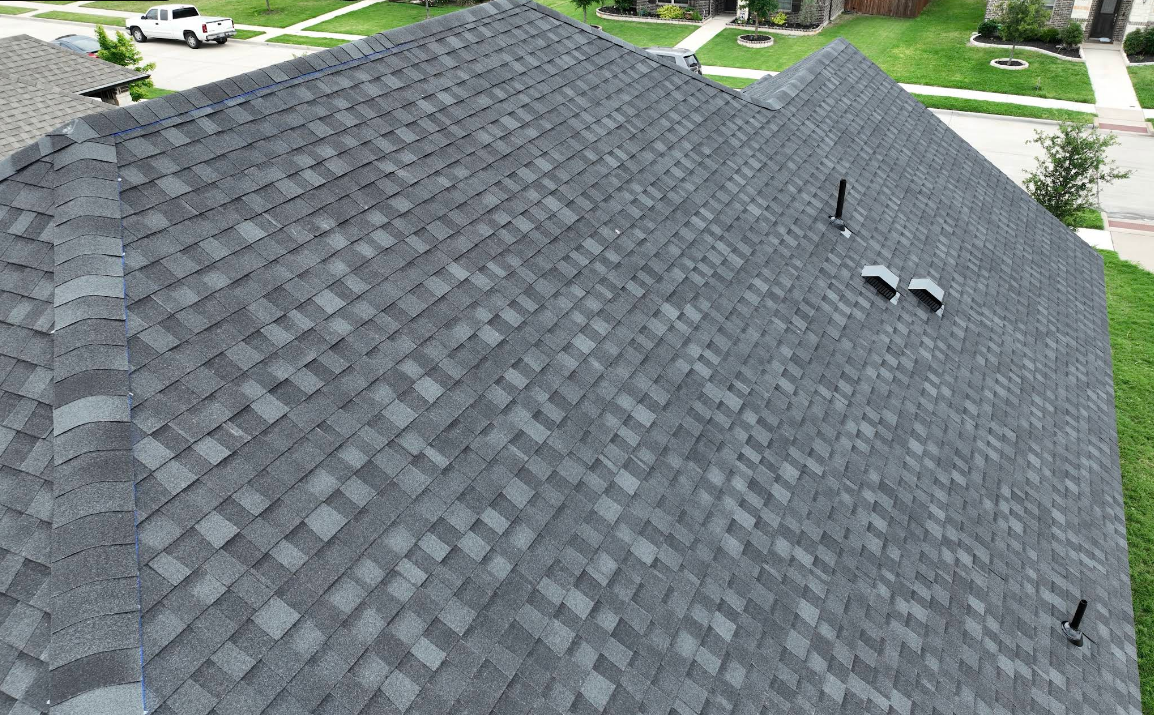 An aerial view of a roof of a house in a residential area.