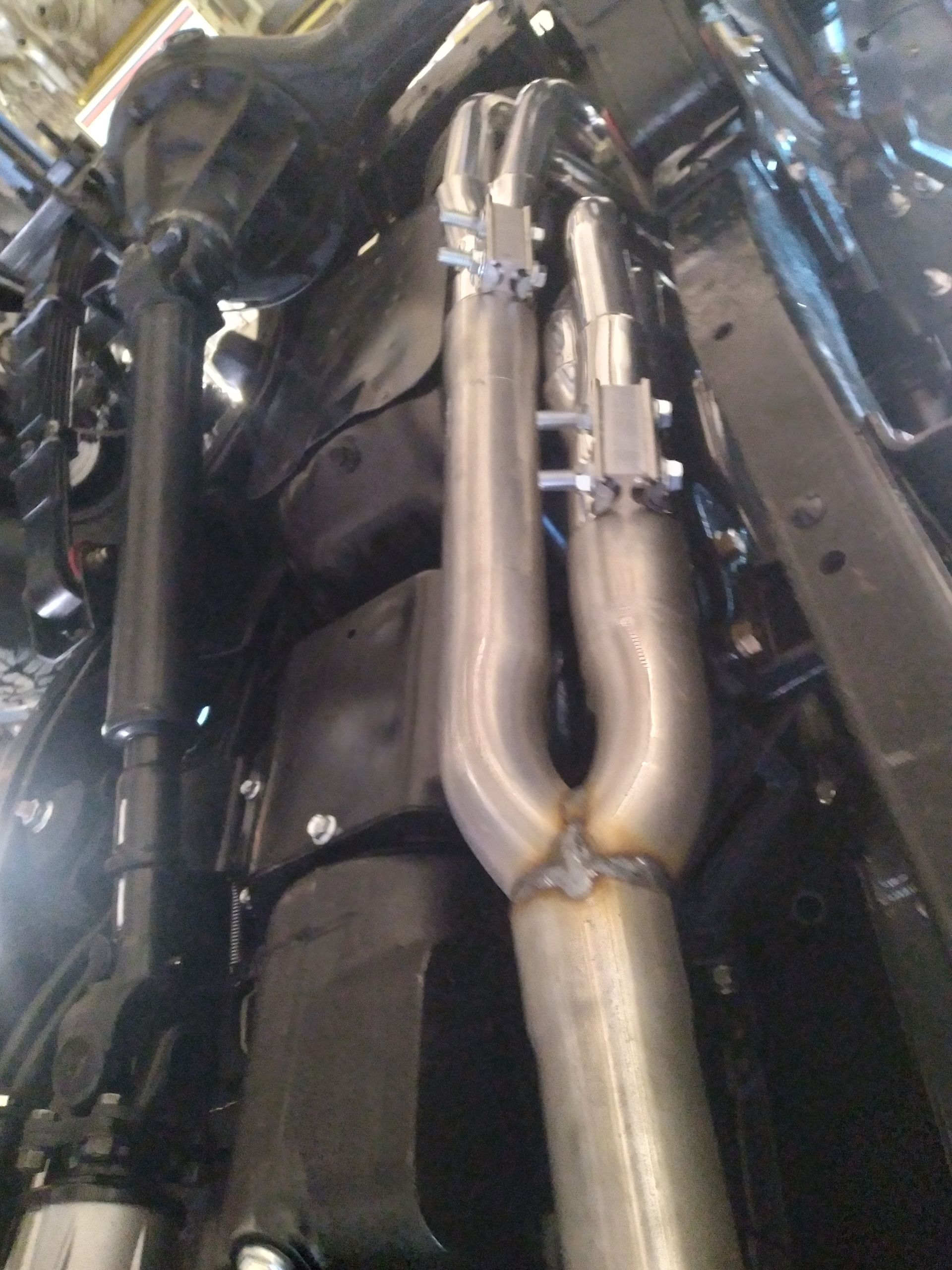 A close up of a exhaust pipe on the underside of a car
