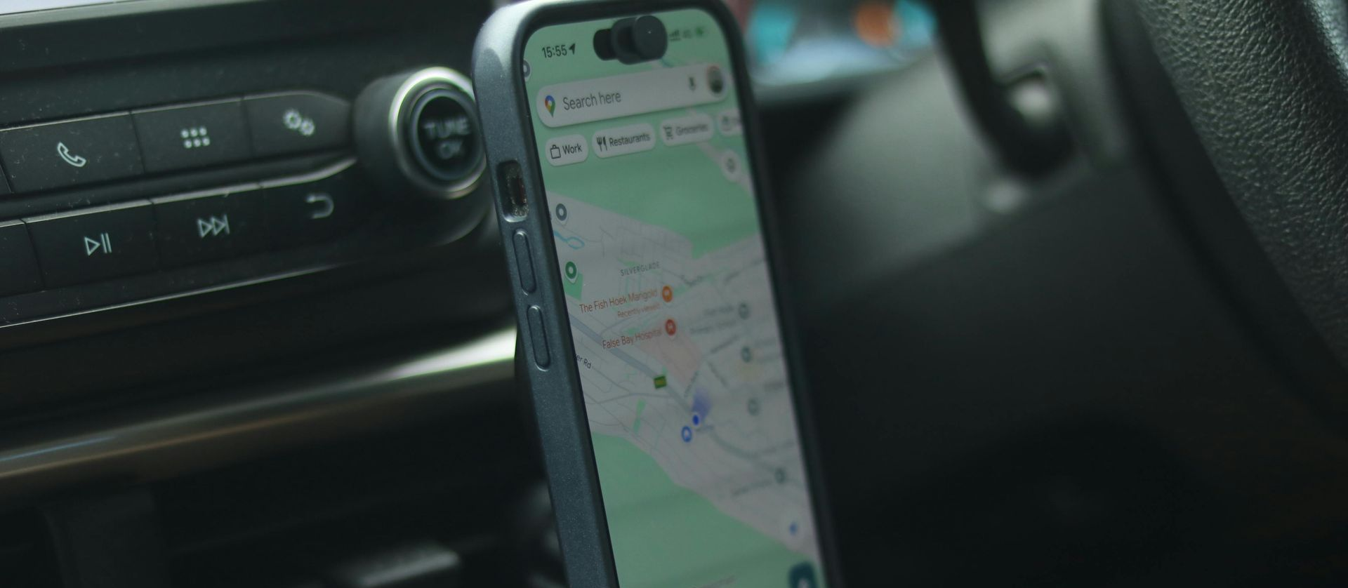 Professional technician installing ceramic window tint on a modern car with precision