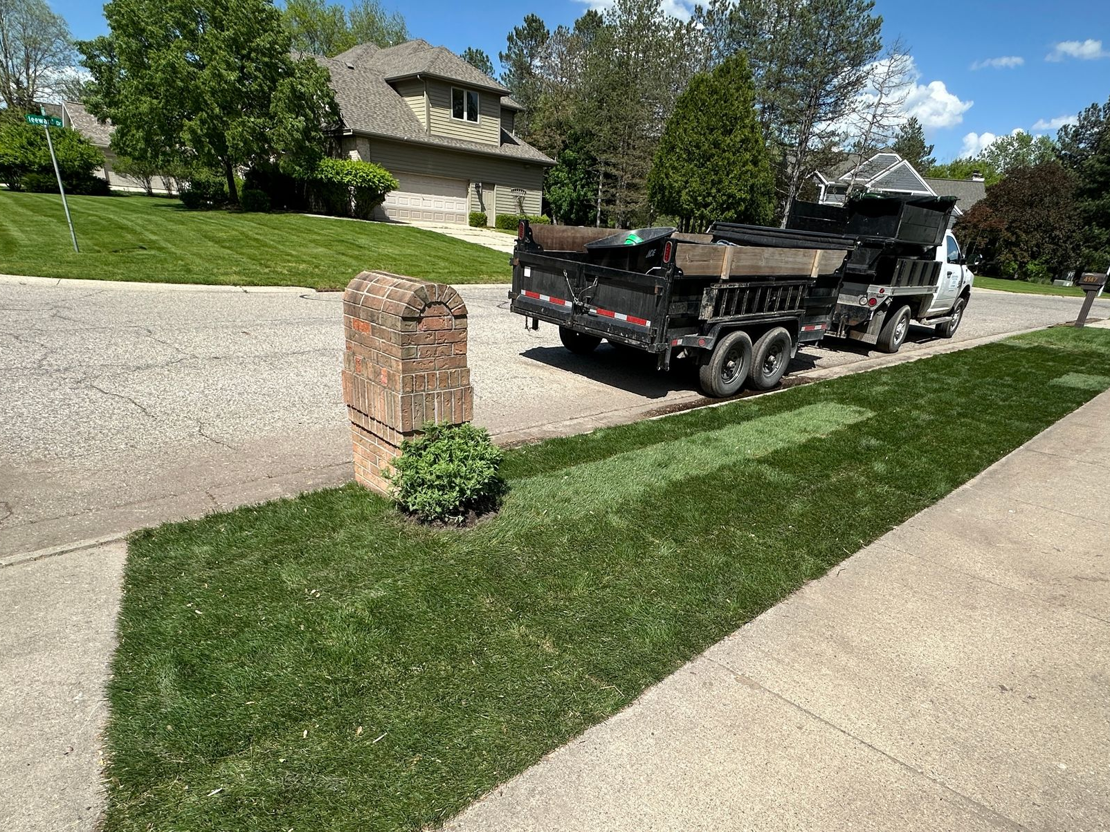 Sod installation along sidewalk and curb in Okemos, MI