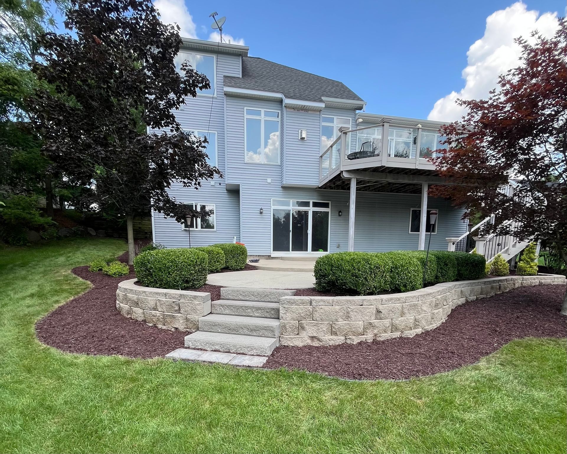 Shrub trimming, landscape bed cleanup, and mulch installation at a residential home in Mason MI